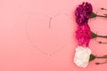 International Womens Day with flowers and heart shape necklace on pink background Royalty Free Stock Photo