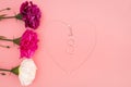 International Womens Day with flowers and heart shape necklace on pink background Royalty Free Stock Photo