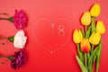 International Womens Day with flowers and heart shape necklace on red background Royalty Free Stock Photo