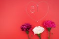 International Womens Day with flowers and heart shape necklace on red background Royalty Free Stock Photo