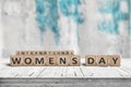 International Womens day sign on a wooden table