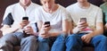 Internet addiction, group of young people looking at their smartphones Royalty Free Stock Photo