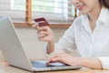 Internet banking, Online shopping at home, happy asian young woman, girl hand in holding credit card, using laptop computer, Royalty Free Stock Photo