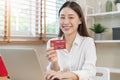 Internet banking, Online shopping at home, happy asian young woman, girl hand in holding credit card, using laptop computer, Royalty Free Stock Photo