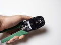 internet cable crimping tool in male hand close up Royalty Free Stock Photo