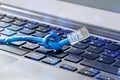 Internet cable with knot on a computer keyboard symbolising bandwidth problems