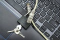 internet cable passing through an open iron lock with keys on a laptop keyboard data protection concept cybercrime