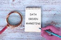 Internet concept. Business concept. Business idea. DATA DRIVEN MARKETING text in a notebook on the background of antique boards