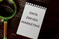 Internet concept. Business concept. Business idea. DATA DRIVEN MARKETING text in a white notebook on a dark mysterious background