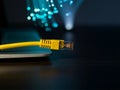 internet connection cable on laptop on table, unfocused fiber optic background Royalty Free Stock Photo