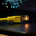 internet connection cable on laptop on table, unfocused fiber optic background Royalty Free Stock Photo