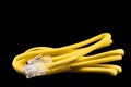 Internet data cable isolated on black background. Internet communication concept. Network internet yellow cable isolated over Royalty Free Stock Photo