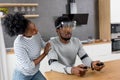 African couple play video games wearing virtual reality glasses at home