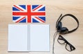 Internet learning of English. Top view of headphones and flag of Great Britain.