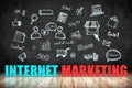 Internet Marketing word on wood floor with doodle icon on blackboard wall,Digital business concept