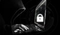 Internet network security system. Hacker in black hoodie using computer laptop Royalty Free Stock Photo