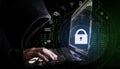 Internet network security system. Hacker in black hoodie using computer laptop and technology lock and application icons
