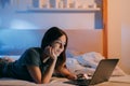 internet night home leisure happy woman laptop bed Royalty Free Stock Photo