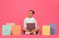 Internet Purchases. Asian Woman Sitting On Floor With Laptop And Shopping Bags Royalty Free Stock Photo