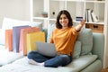 Internet Purchases. Happy Young Arab Female Using Laptop And Showing Credit Card Royalty Free Stock Photo