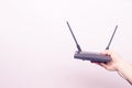 Internet router in your hand on a light background Royalty Free Stock Photo