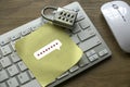 Internet and security concept with a padlock, computer keyboard and yellow paper with a password