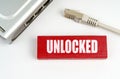 There is a router on the table, disconnected from the network, next to a plaque with the inscription - Unlocked Royalty Free Stock Photo