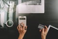 Internet shopping concept.Top view of hands working with calculator and laptop and credit card and tablet computer on dark wooden Royalty Free Stock Photo