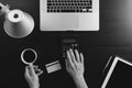 Internet shopping concept.Top view of hands working with calculator and laptop and credit card and tablet computer on dark wooden Royalty Free Stock Photo