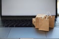 Internet shopping. Small bags and boxes on modern laptop, space for text Royalty Free Stock Photo