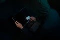 Internet Theft - a man holding a credit card while sat behind a laptop Royalty Free Stock Photo