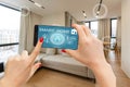 Internet of things, iot, smart home, kitchen and network connect concept. Human hand holding phone and smart home Royalty Free Stock Photo