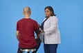 Internist measuring blood pressure of unrecognizable patient