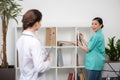Internist talking with doctor in clinical office, focus on background