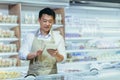 Internship at work. A young man, an Asian stager,student, an assistant works in a supermarket