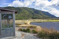 An interpretive hut with a view of Rakatu Wetlands in the South Island of New Zealand. Royalty Free Stock Photo