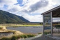 An interpretive hut with a view of Rakatu Wetlands in the South Island of New Zealand. Royalty Free Stock Photo