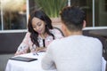 Interracial Blind Date in Outdoor Restaurant Royalty Free Stock Photo