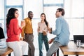 interracial business colleagues having conversation during coffee break Royalty Free Stock Photo