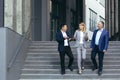 Interracial business meeting. Two business men and one woman near the office. Talking to each other Royalty Free Stock Photo