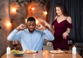Interracial Couple Arguing. Young Multicultural Lovers Having Conflict During Date In Restaurant Royalty Free Stock Photo