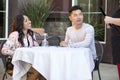 Dating Couple Ordering at an Outdoor Restaurant Royalty Free Stock Photo