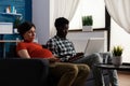 Interracial couple expecting child and using technology Royalty Free Stock Photo