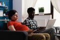 Interracial couple expecting child and using technology Royalty Free Stock Photo