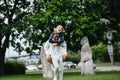 Interracial couple has fun and laughs in park on background of statues Polovtsian women