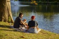 An interracial couple having picnic by a lake on a suny afternoon