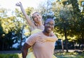 Interracial couple, piggy back and portrait of people with love, care and smile on summer park date. Happiness, hug and Royalty Free Stock Photo