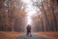 Interracial couple posing in autumn park road Royalty Free Stock Photo