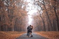 Interracial couple posing in autumn park road Royalty Free Stock Photo