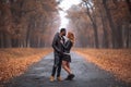 Interracial couple posing in autumn park road Royalty Free Stock Photo